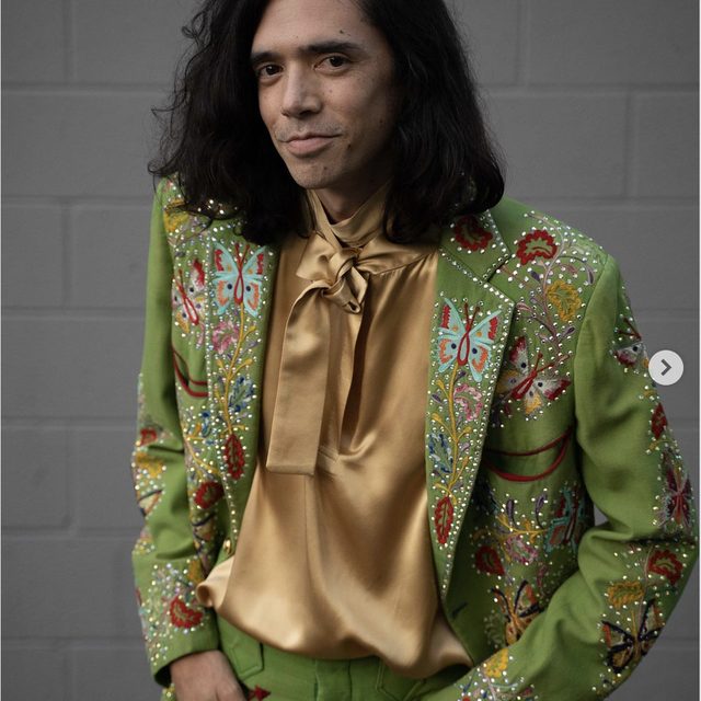 Creator Trnrtips in an embellished green suit for the Music track